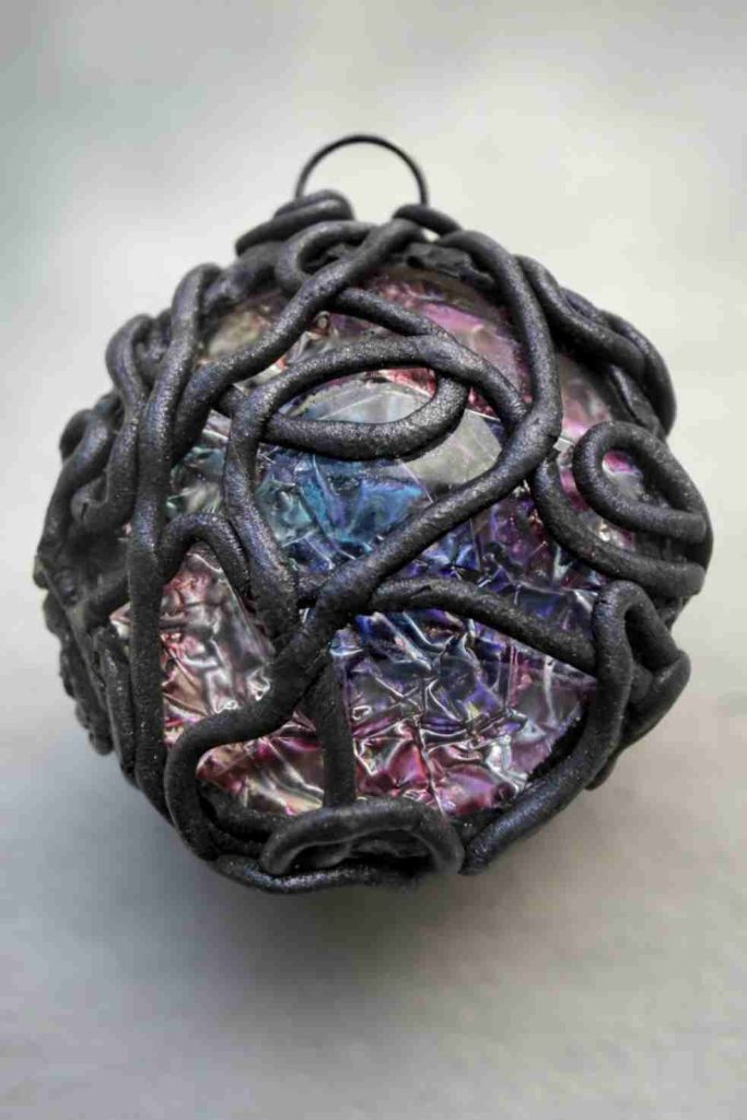 Glass pendant wrapped in wiry polymer clay