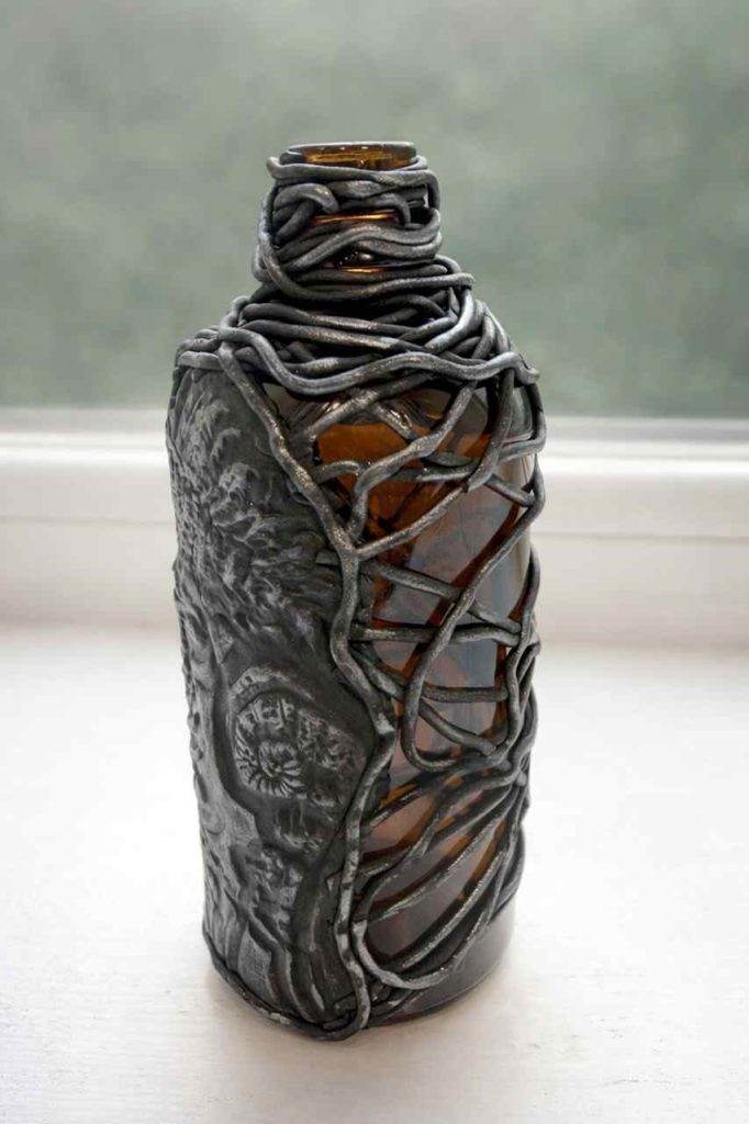 Small brown incense bottle dressed in metallic polymer clay