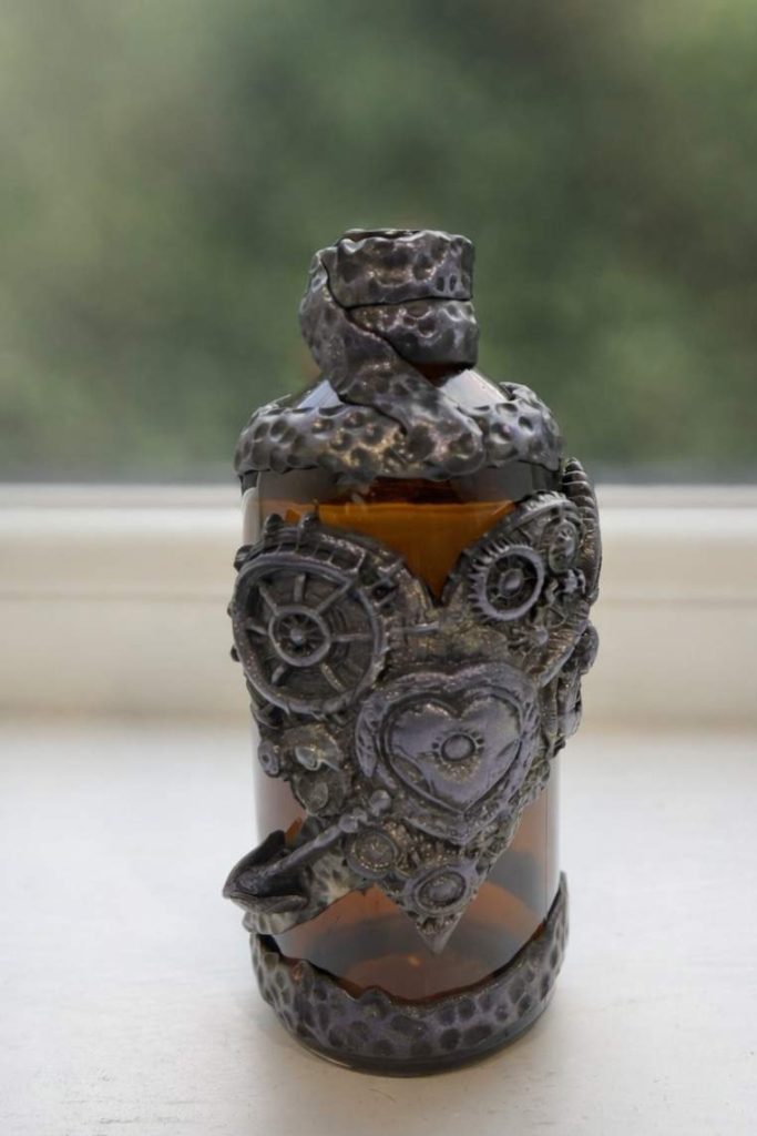 Small brown incense bottle dressed in polymer clay love heart motif